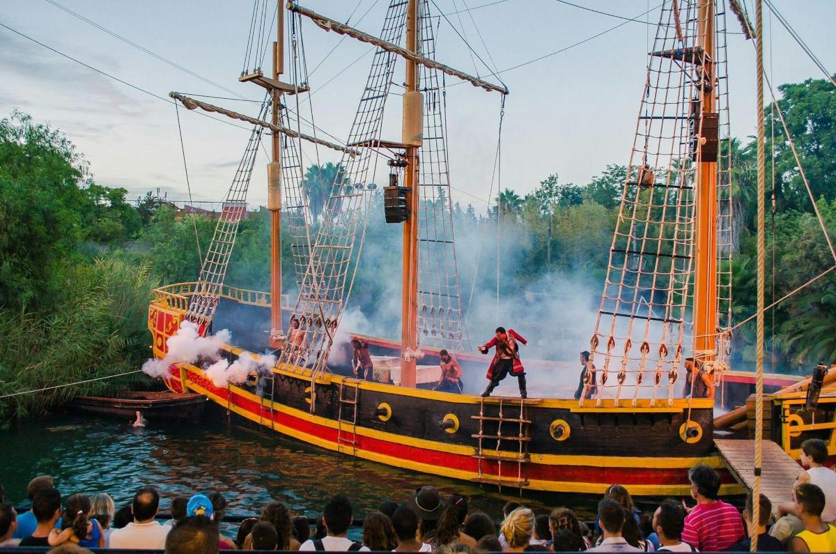 a man standing on the side of a pirate ship