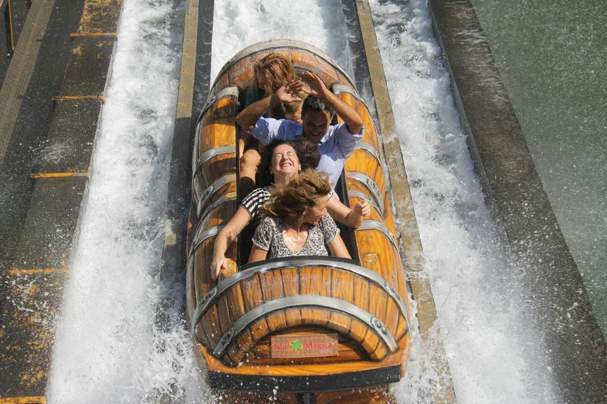 a group of people riding a roller coaster in a waterfall