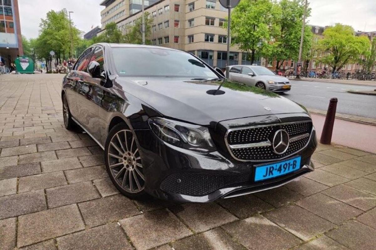 a black car parked on the side of a street