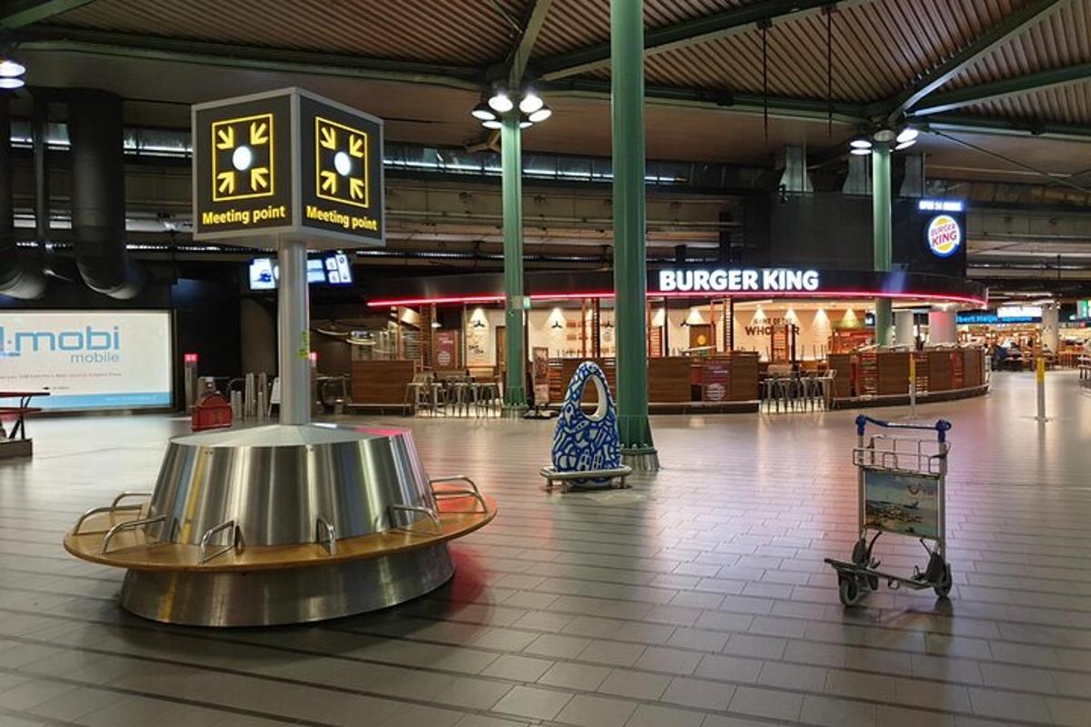 an empty shopping mall with a clock in the middle