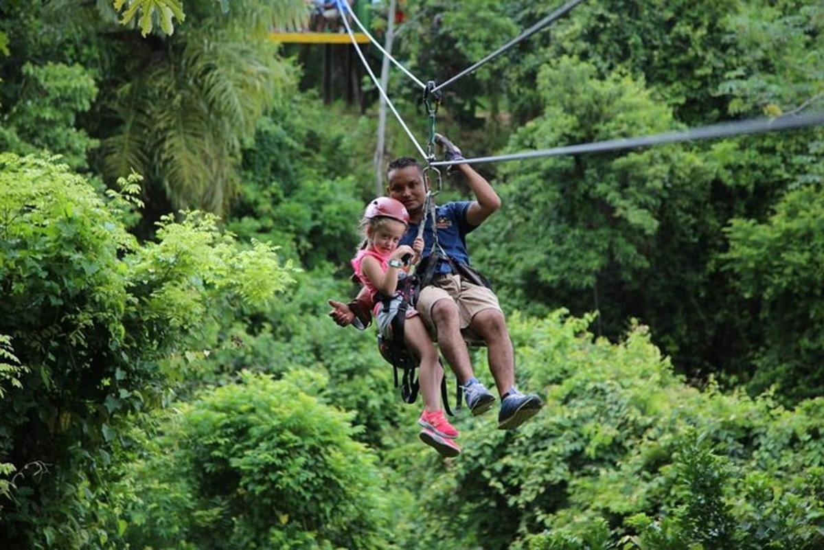 two people on a zip line in the jungle