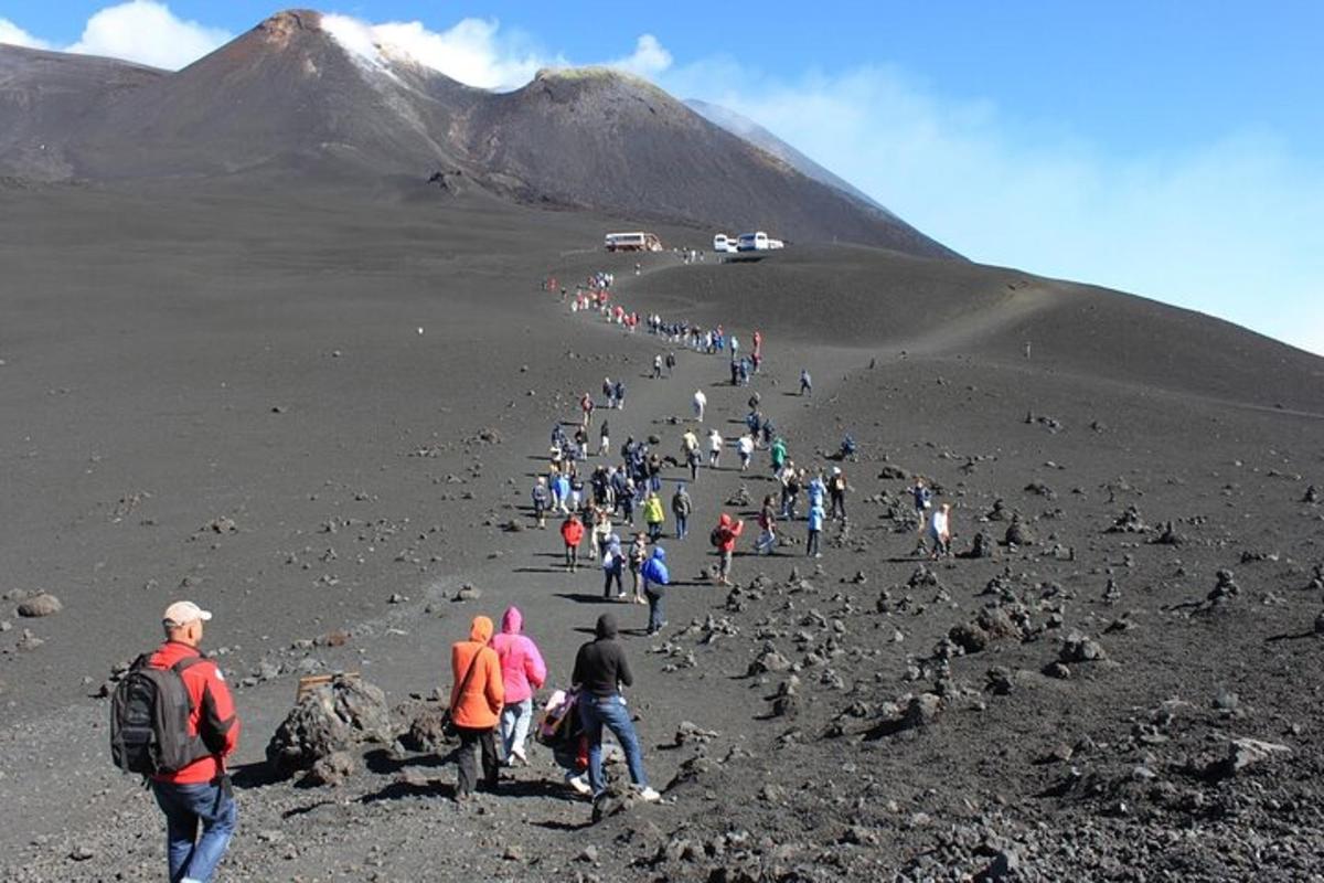 a large group of people walking on a mountain