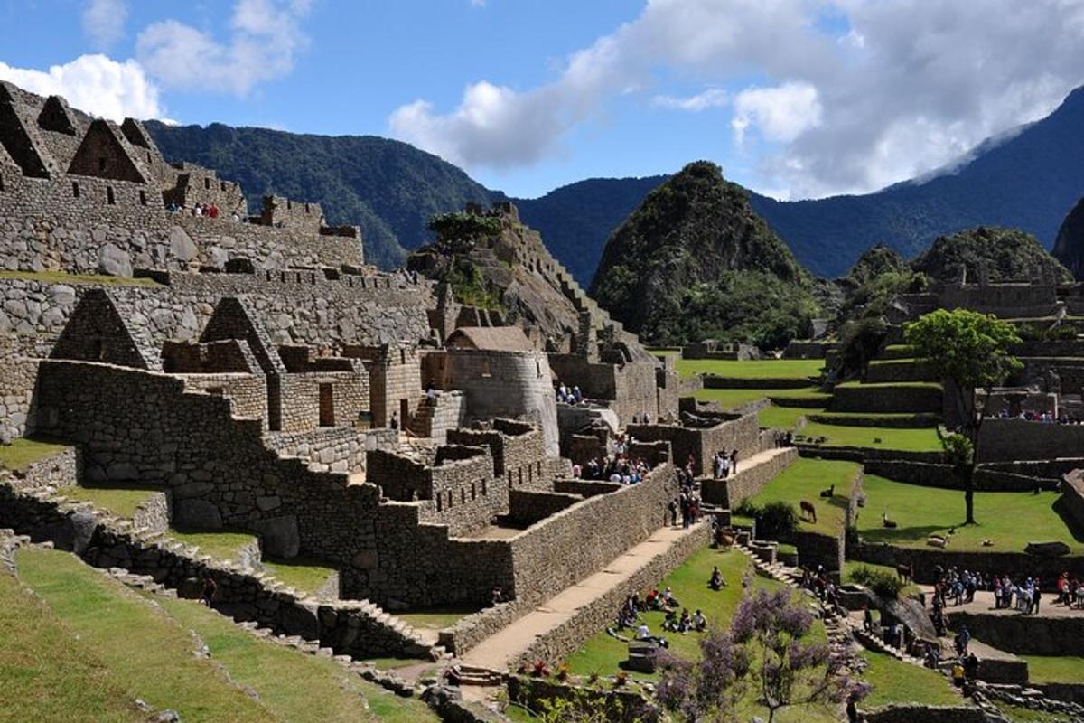 an ancient amphitheater with mountains in the background