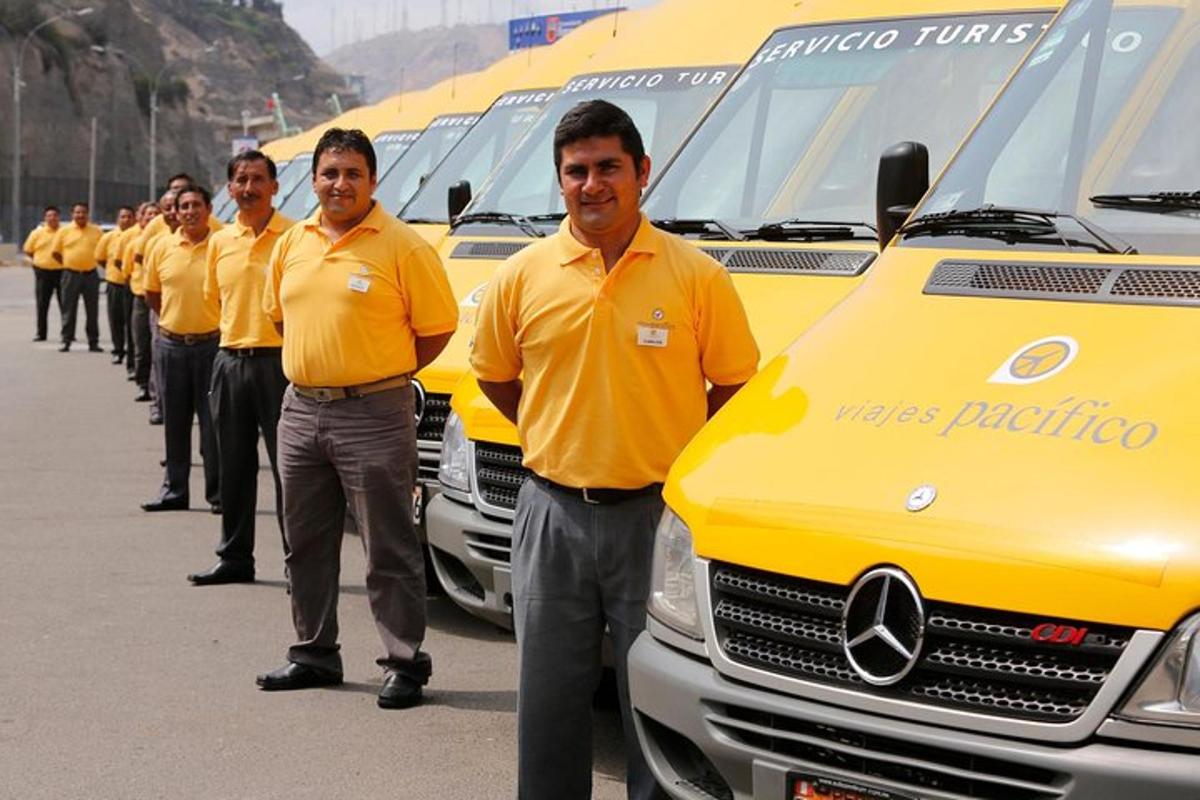a group of men in yellow shirts standing next to a truck