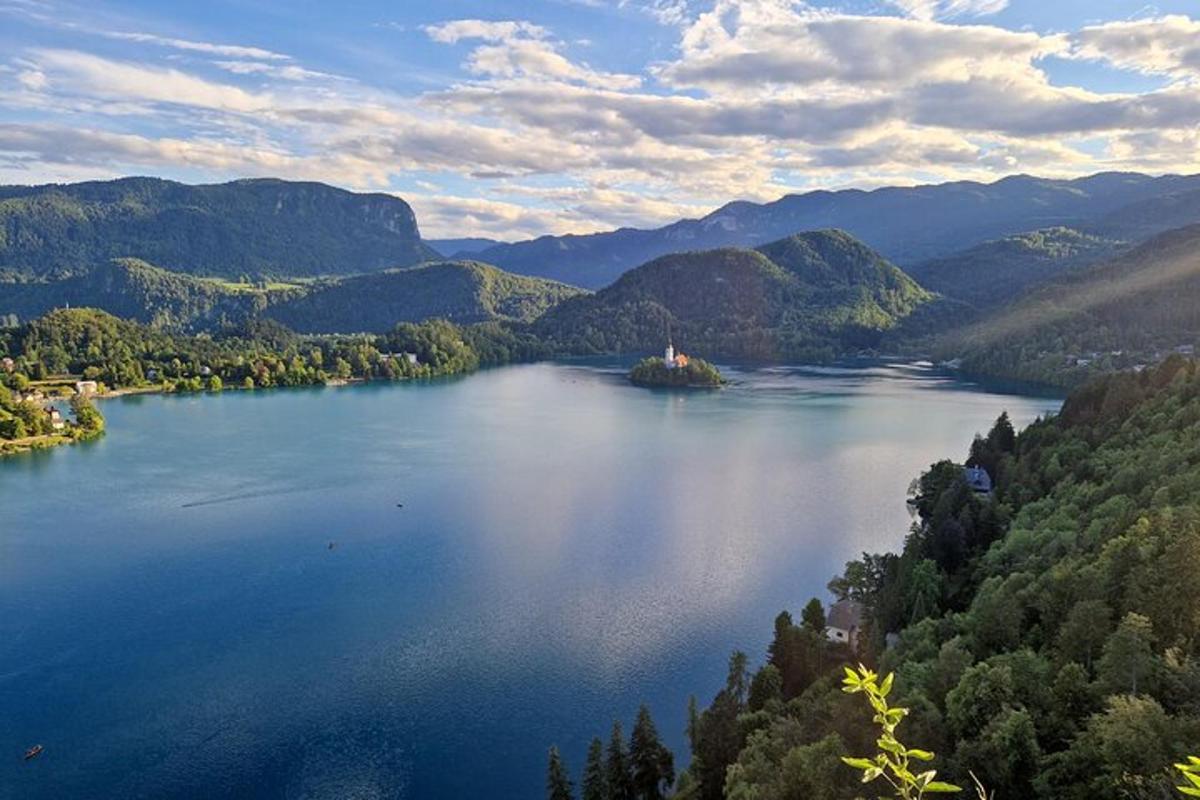 an island in a large body of water with mountains