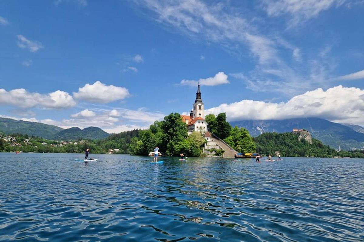 a group of people on a lake with a church