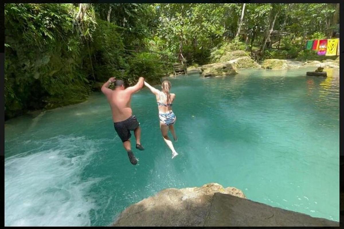 two people jumping into a river in the water