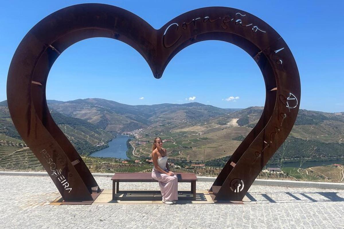 a woman sitting on a bench in the shape of a heart