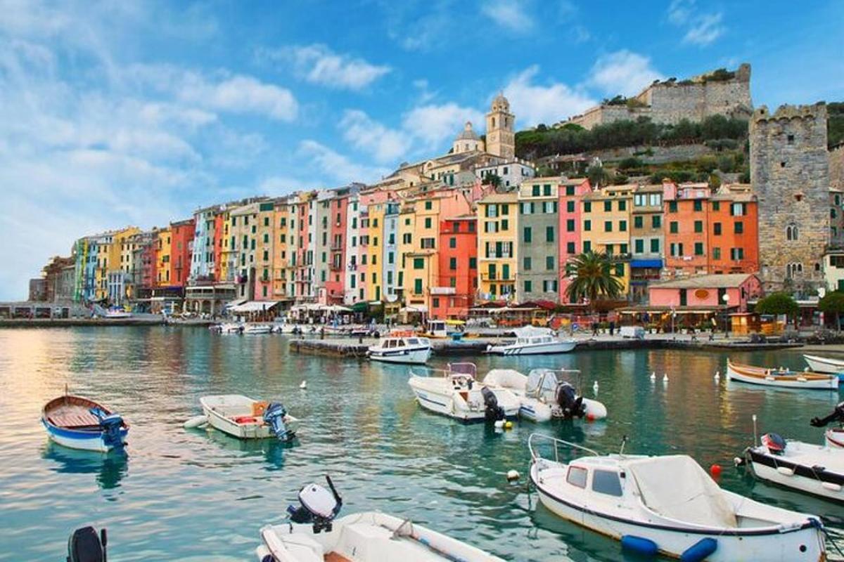 a group of boats docked in a harbor with buildings