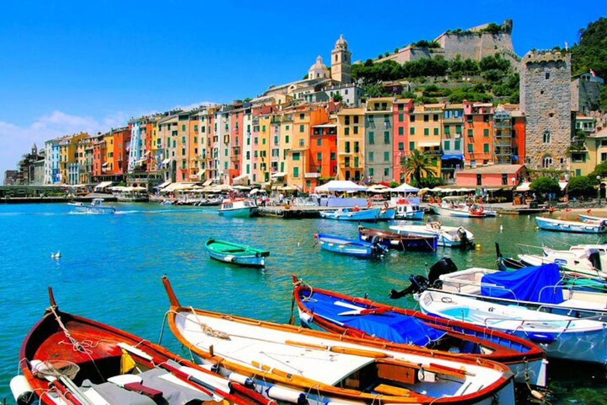 a group of boats docked in a harbor with buildings