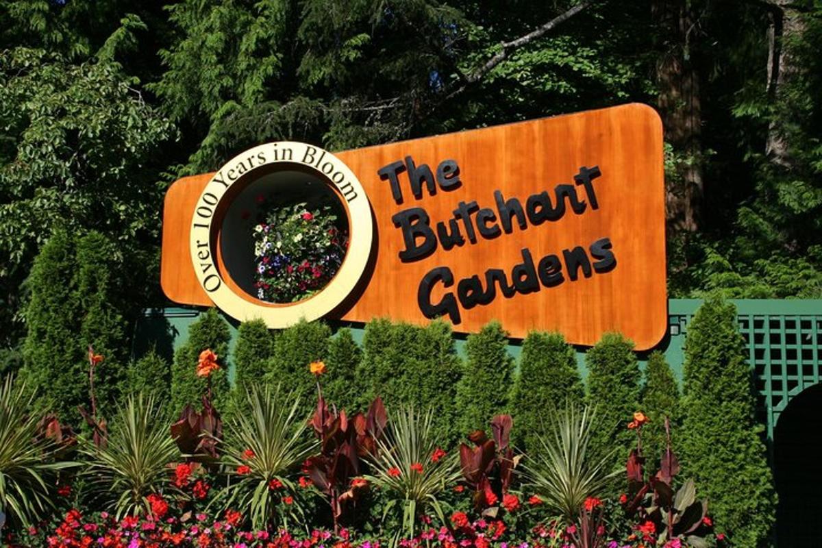 uma placa para o jardim de borboletas em um parque temático
