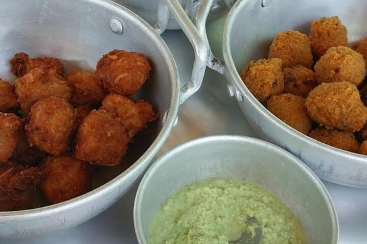 three bowls of food on a counter with dipping sauce