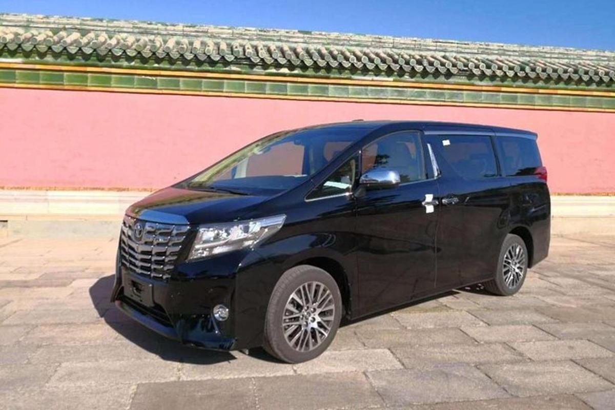 a small black car parked in a parking lot