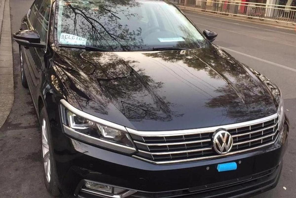 a black car parked on the side of a street