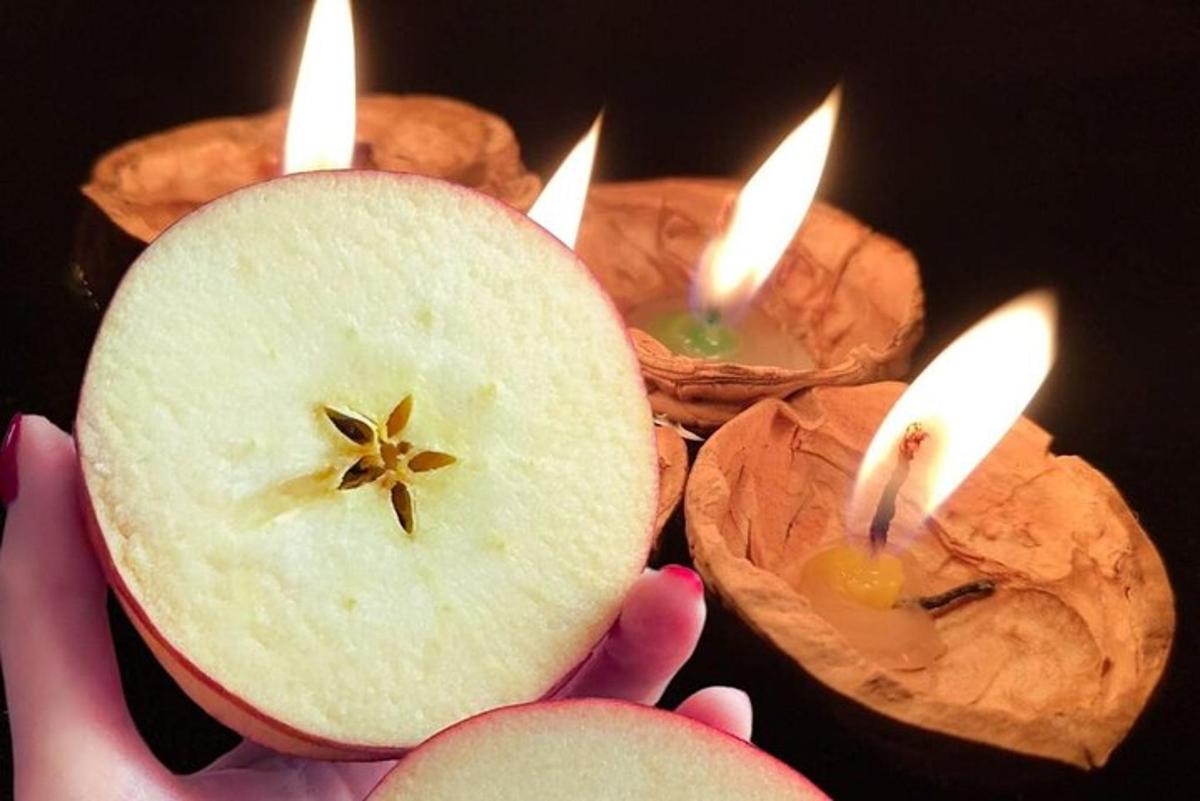 a person holding a candle with lit candles