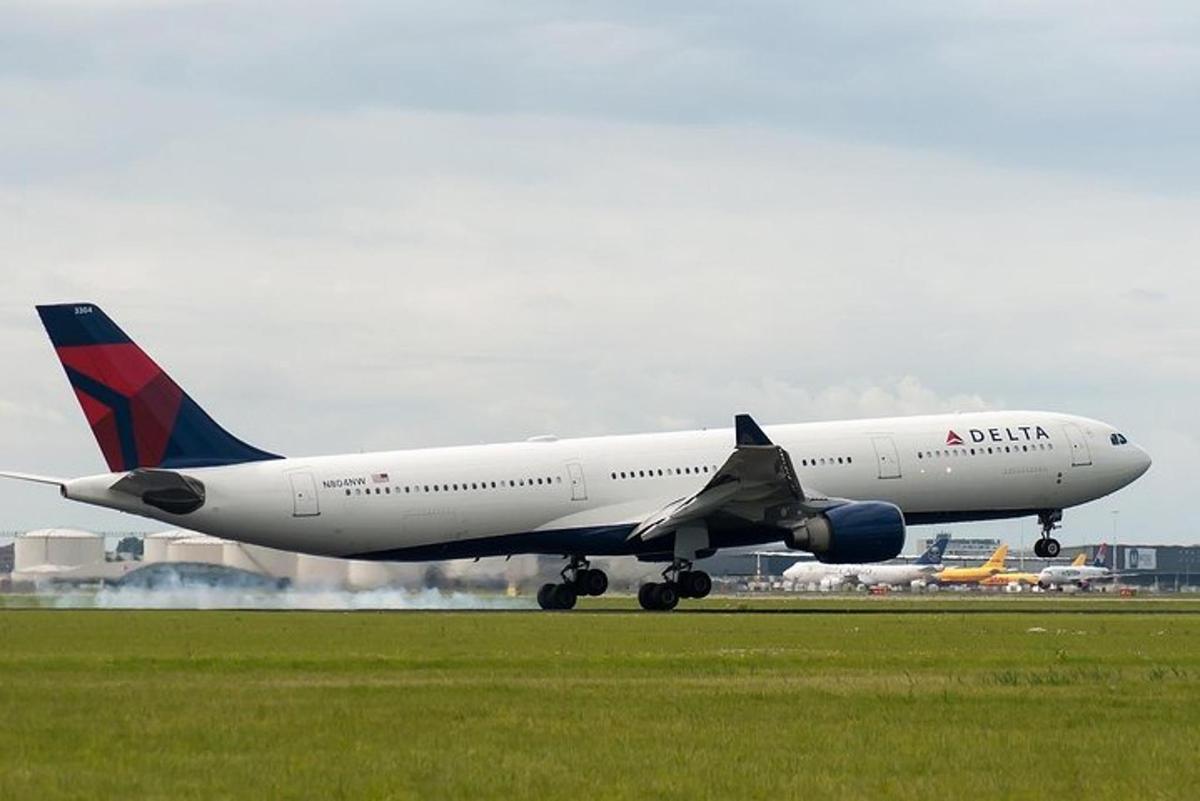 a delta airplane taking off from an airport runway