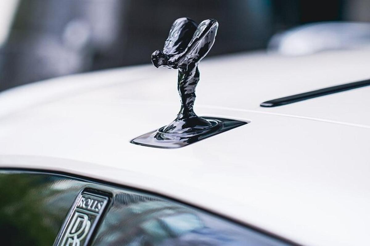 a chrome hood ornament on a white car