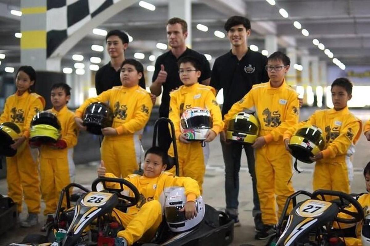 a group of men in yellow suits holding helmets