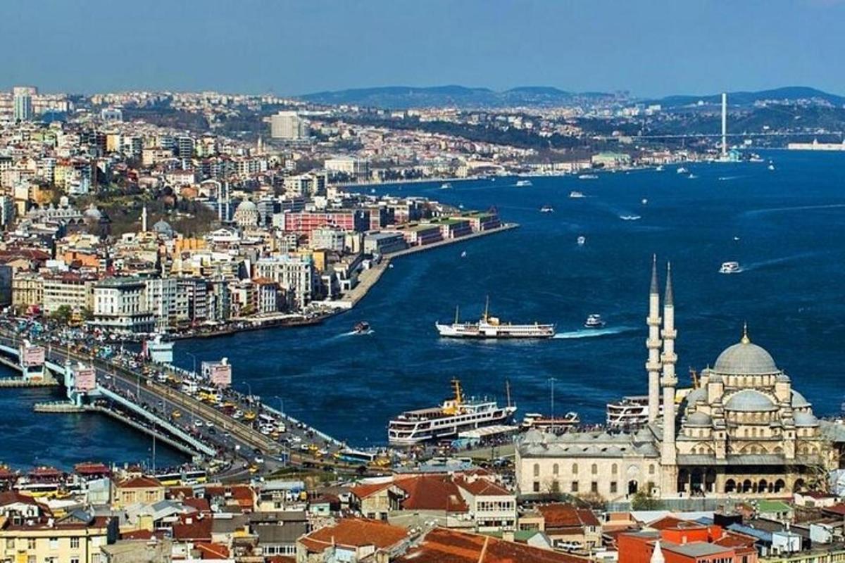 an aerial view of a city with a river and a mosque