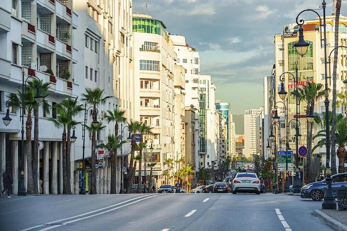 eine Stadtstraße mit Autos, die eine Straße mit Gebäuden entlangfahren
