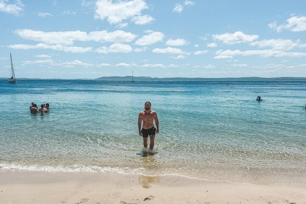 a man standing in the water on the beach
