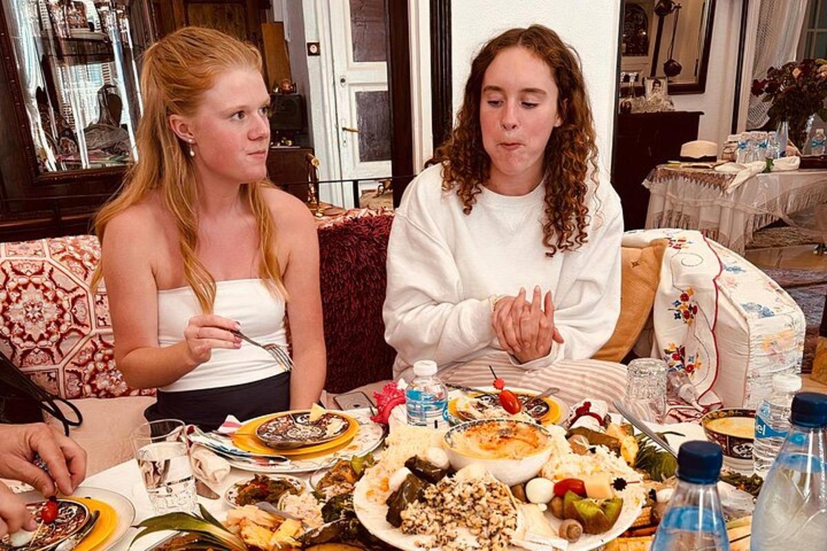 two women sitting at a table eating food