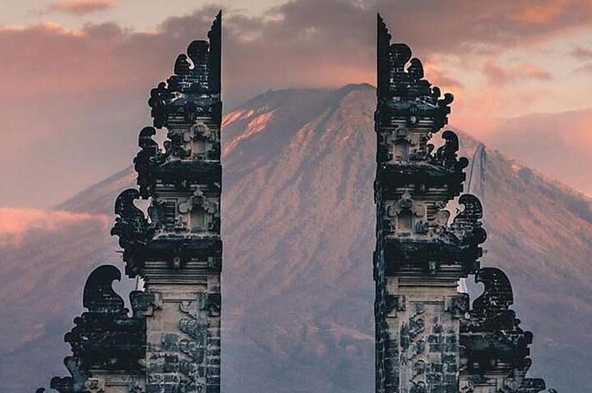 two towers with a mountain in the background