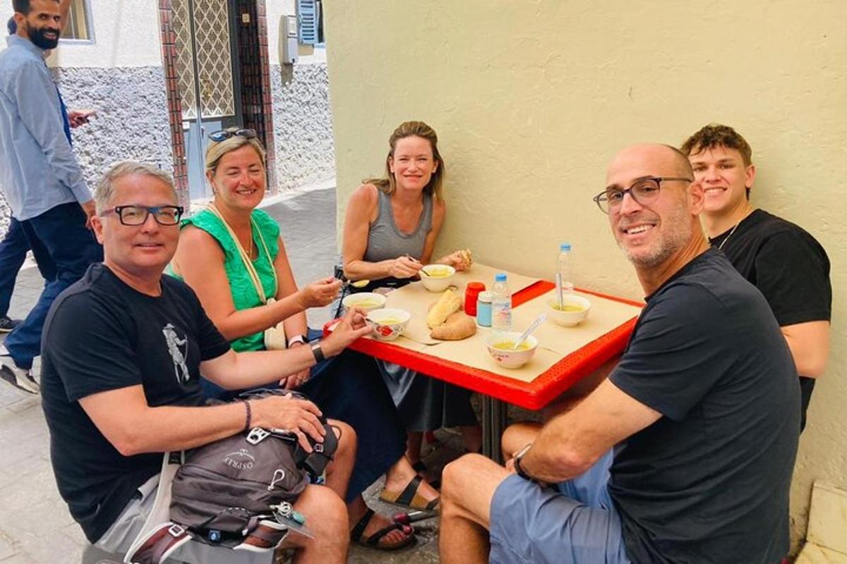 a group of people sitting around a table eating food