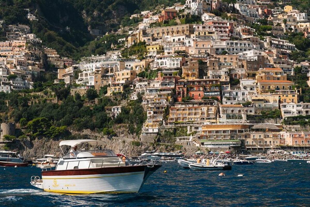 a boat in the water in front of a mountain