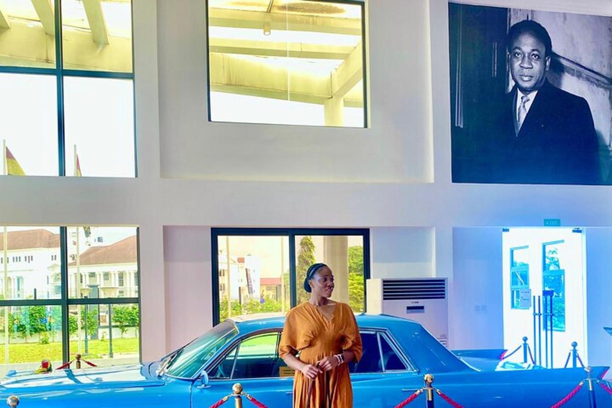 a woman standing in front of a car in a building