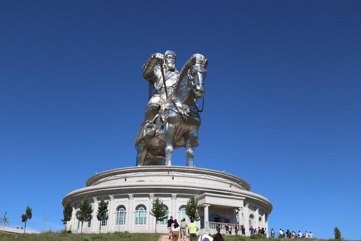 a statue of a man on a horse in front of a building