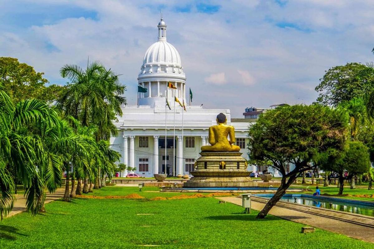 a white building with a statue in front of it