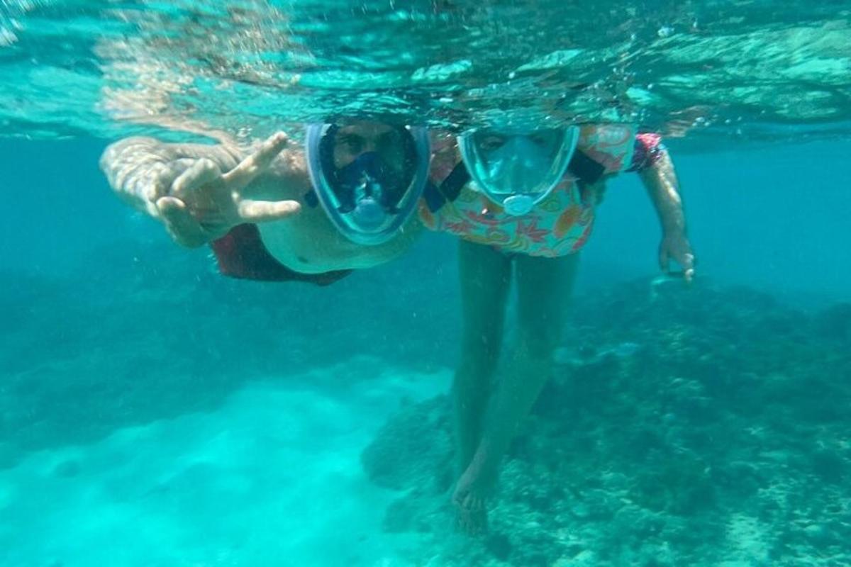 a person with a pair of goggles swimming in the water