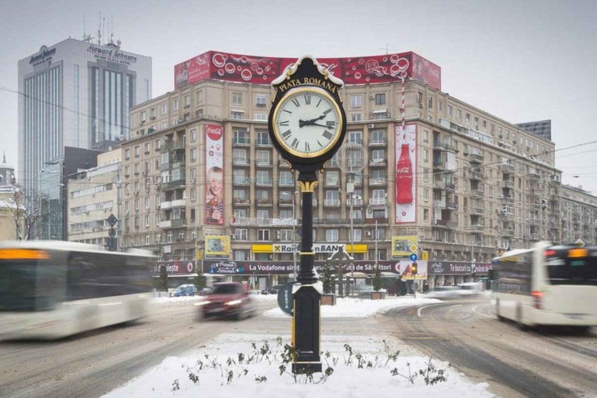 a clock on a pole in the middle of a street