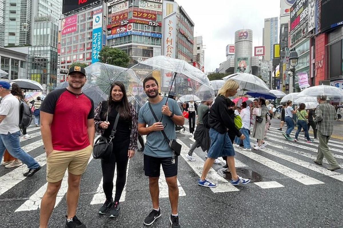 a group of people walking in the street with umbrellas