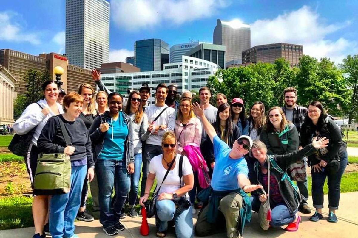 a group of people posing for a picture in front of a city
