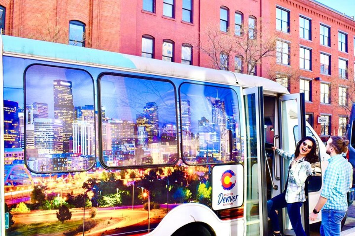 a group of people standing next to a bus