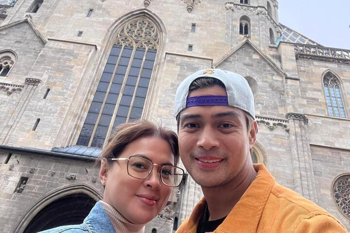 a man and a woman standing in front of a church