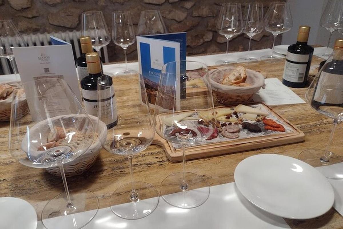 a table with wine glasses and a tray of food