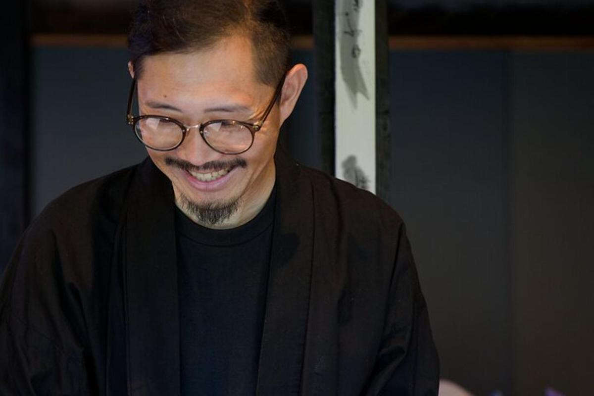 a man in glasses wearing a black robe