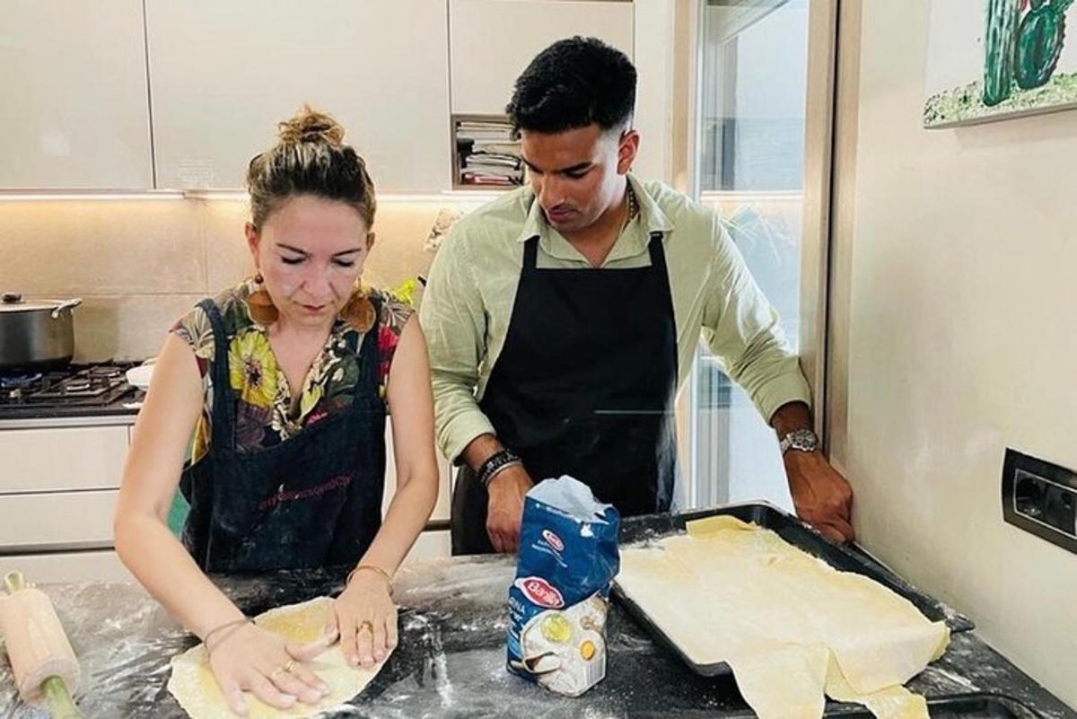 a man and a woman in the kitchen preparing food