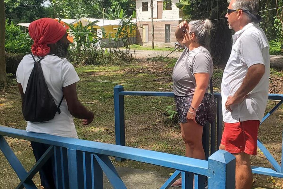 un gruppo di persone in piedi accanto a una recinzione blu