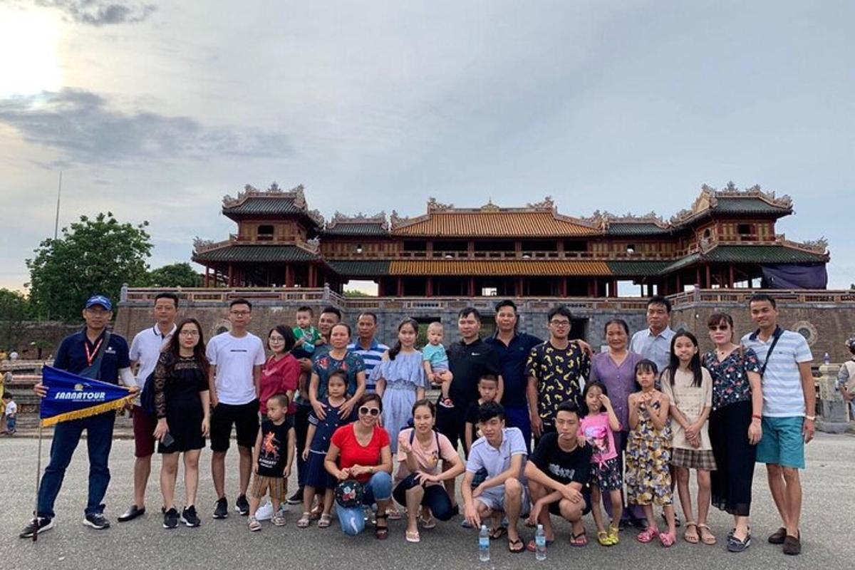 a group of people posing for a picture in front of a building