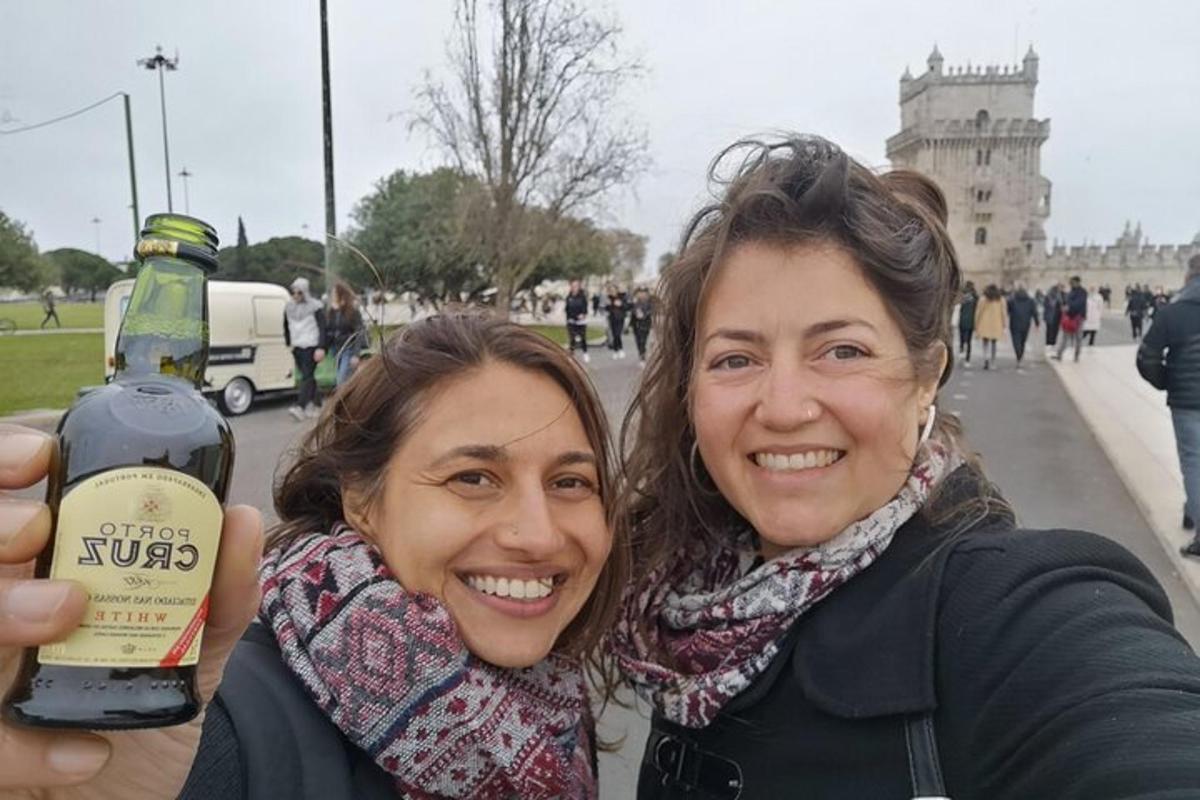 Dos mujeres sostienen una botella de vino.