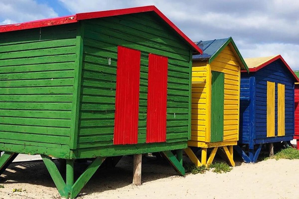 a row of colorful beach huts on the beach