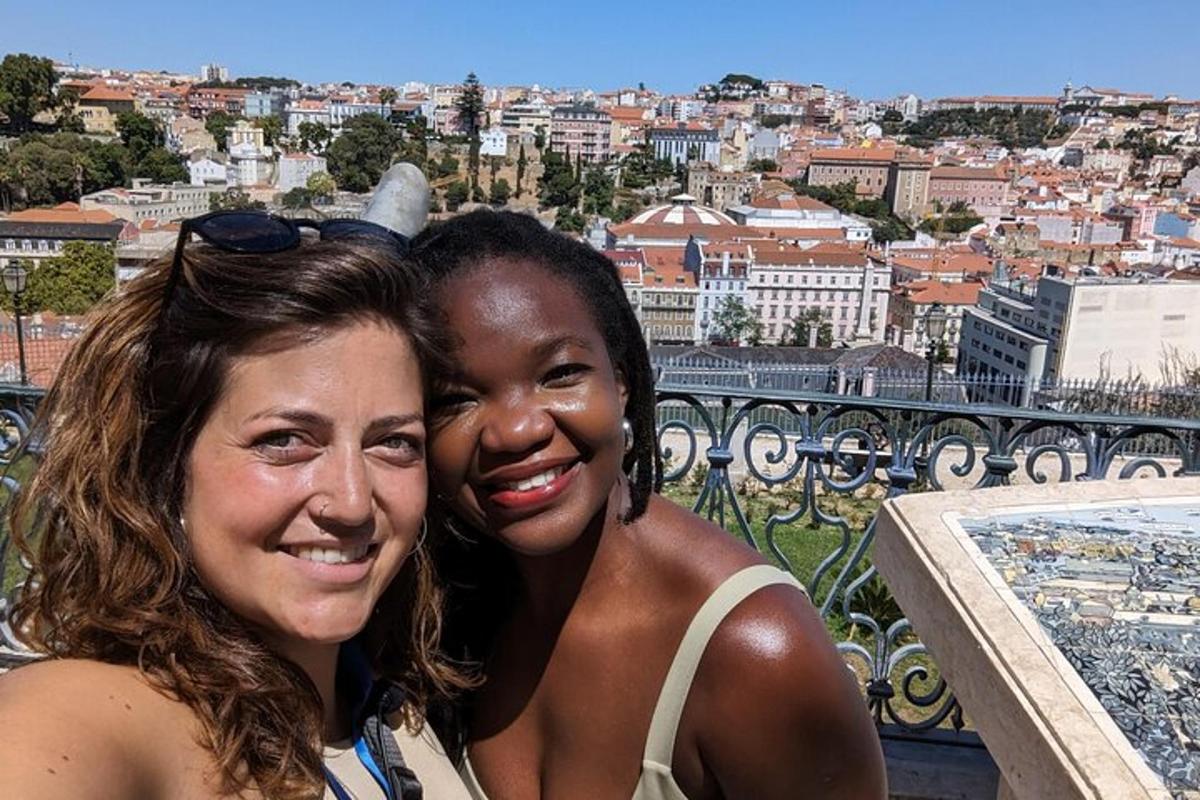 due donne posano per una foto con vista sulla città