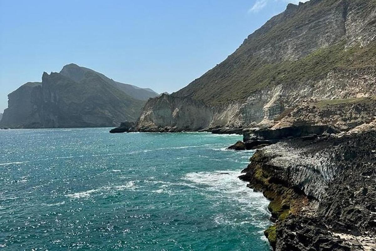 a large body of water next to a mountain