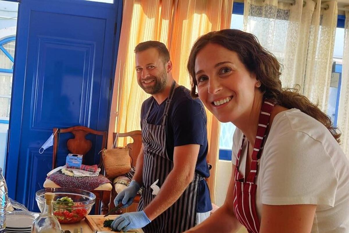 a man and a woman in a kitchen preparing food