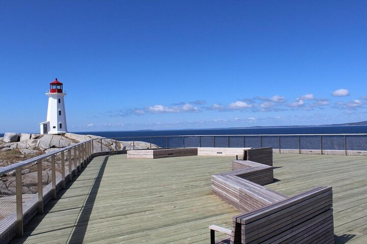 a lighthouse on a pier with benches and a lighthouse