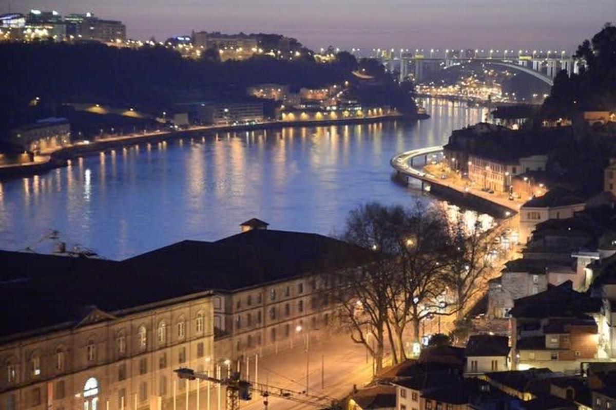 a view of a river at night with a city